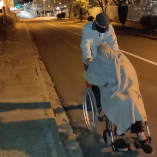 Un señor de 94 años, obligado a empujar la silla de su mujer con alzhéimer por falta de ambulancias