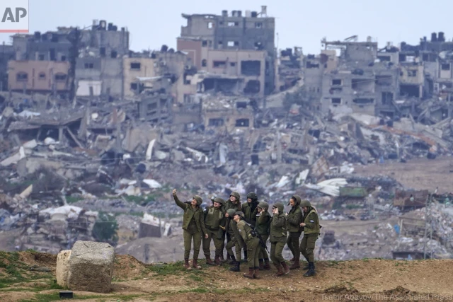 Mujeres soldado israelies posan para un selfie junto a la ruinas de Gaza